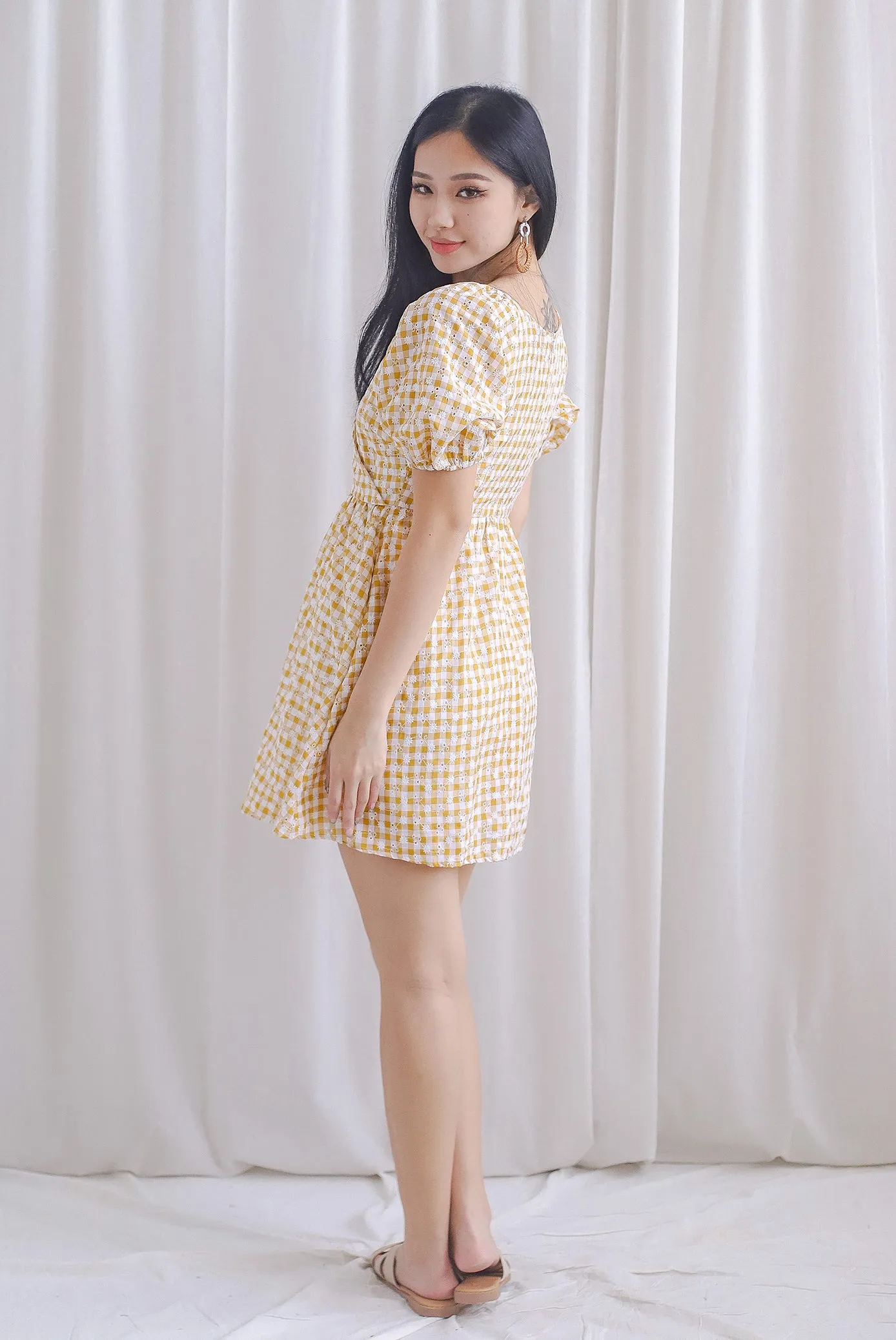 Evvie Gingham Embro Faux Wrap Romper In Yellow