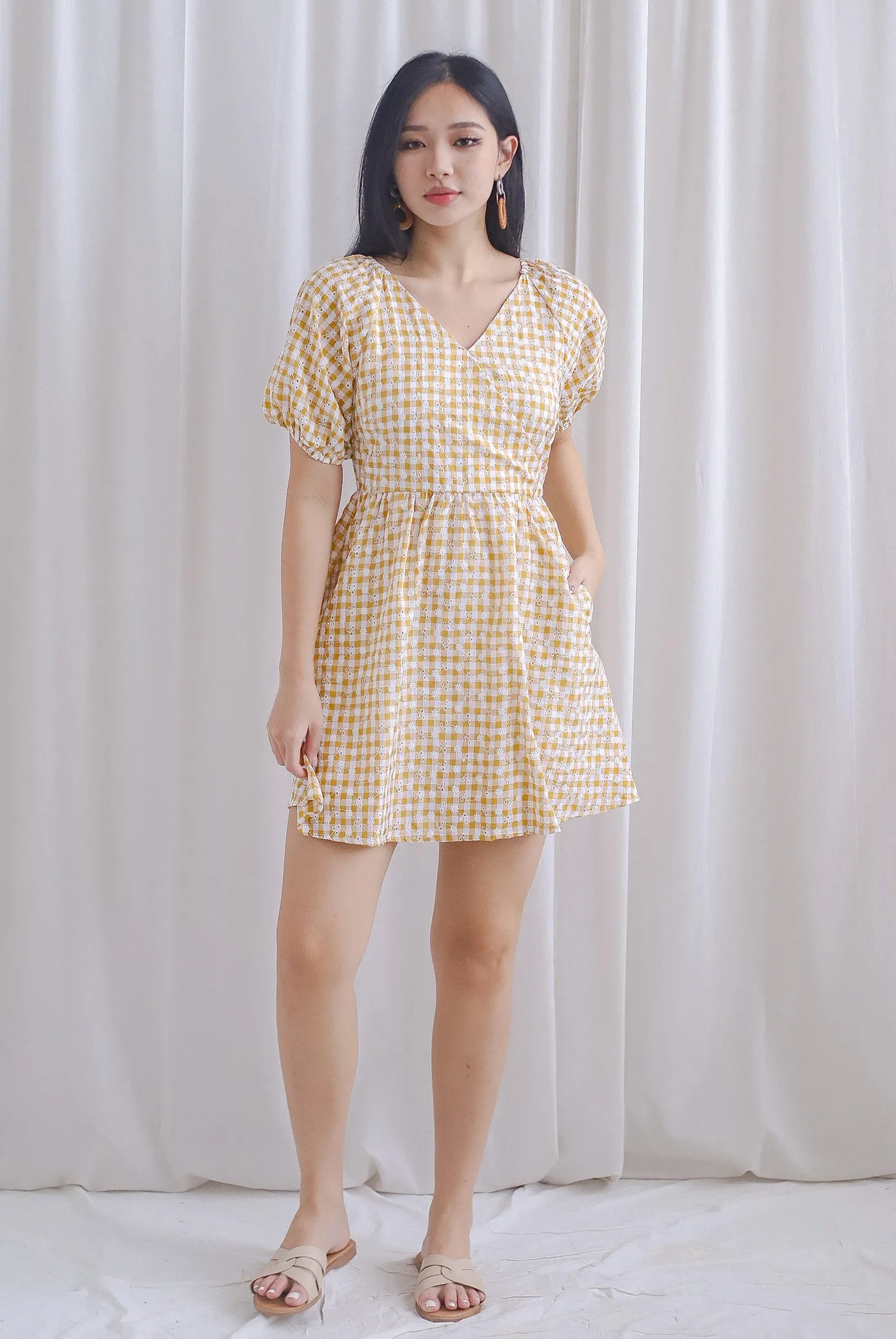 Evvie Gingham Embro Faux Wrap Romper In Yellow