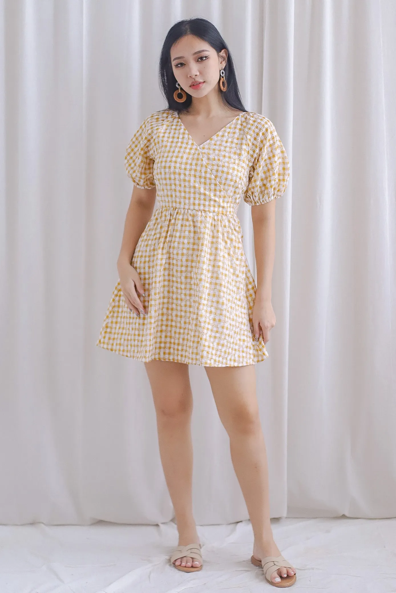 Evvie Gingham Embro Faux Wrap Romper In Yellow