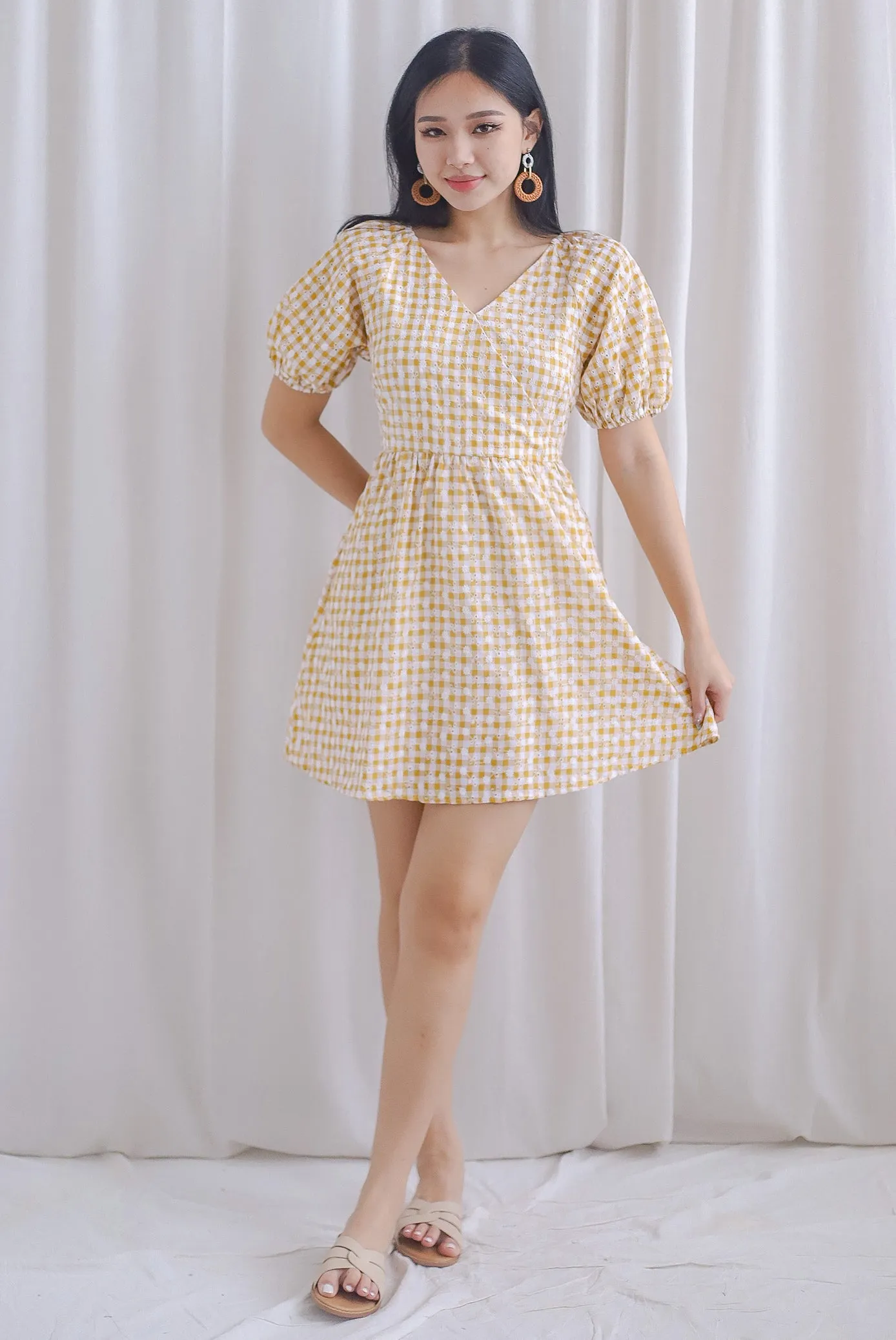 Evvie Gingham Embro Faux Wrap Romper In Yellow